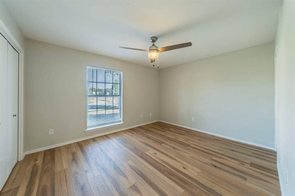 802 Birchwood Drive, Garland, TX 75043 Wood-finish flooring with a neutral wall palette