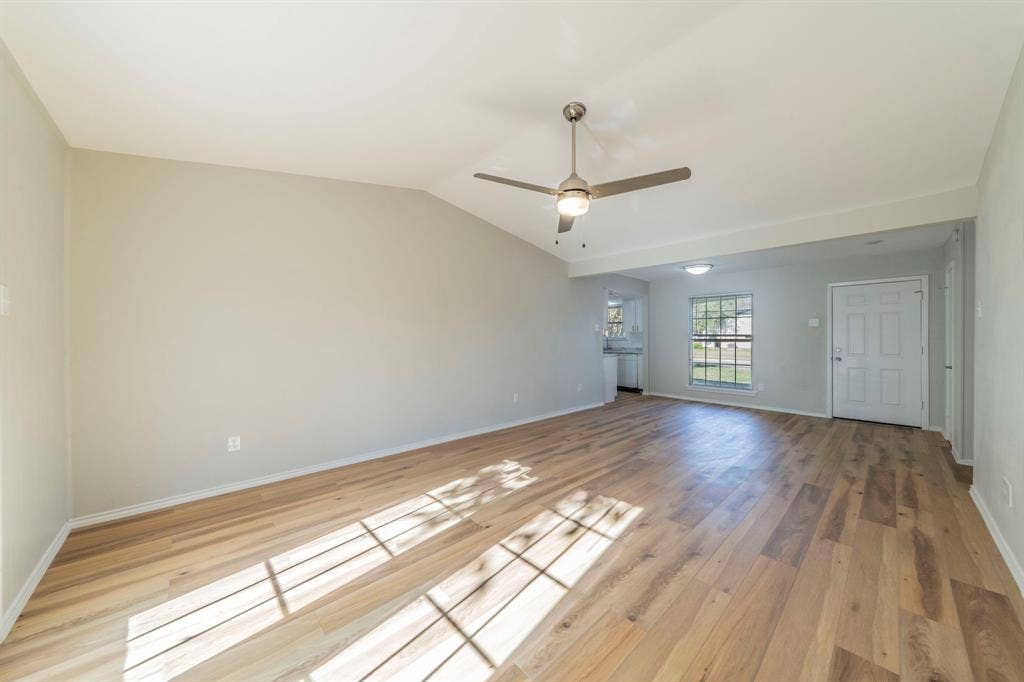802 Birchwood Drive, Garland, TX 75043 Vaulted ceiling, wood-finish flooring, ceiling fan with integrated lighting, recessed lighting, and a paneled entry door
