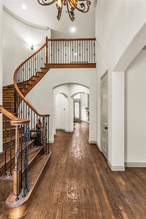 1838 Olney Drive, Allen, TX 75013 Grand entryway featuring a curved staircase with wood treads and wrought iron balusters