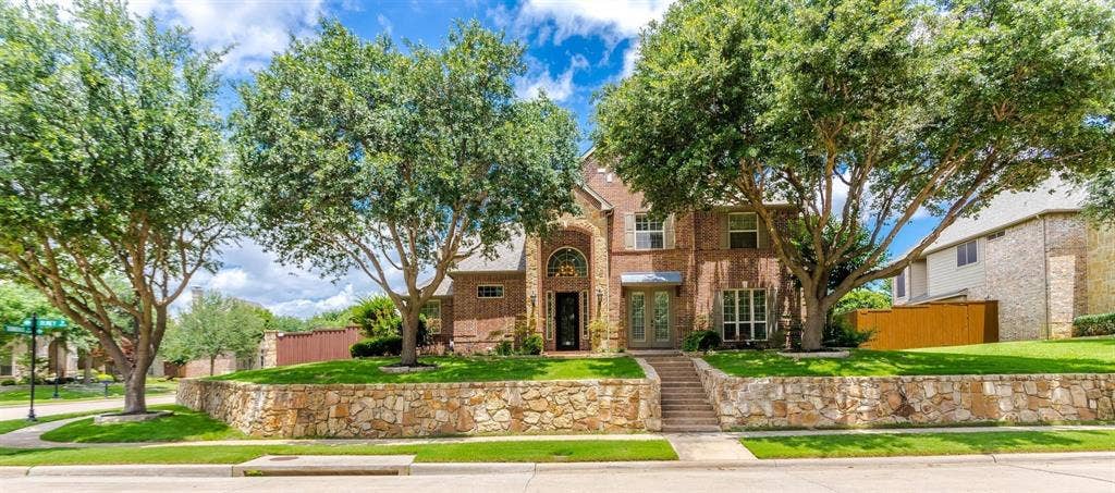 1838 Olney Drive, Allen, TX 75013 Brick exterior with stone accents and a stone retaining wall