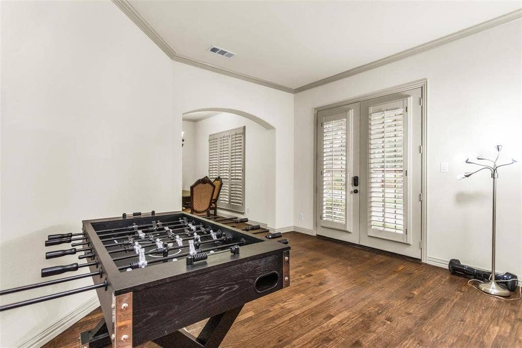 1838 Olney Drive, Allen, TX 75013 Arched entryway, wood-finish flooring, crown molding, and plantation shutters on French doors