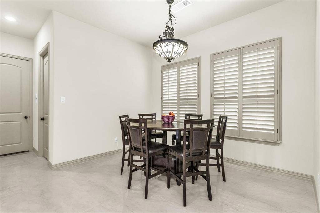 1838 Olney Drive, Allen, TX 75013 Light-toned walls, arched interior door, tile flooring, interior plantation shutters, and a decorative chandelier