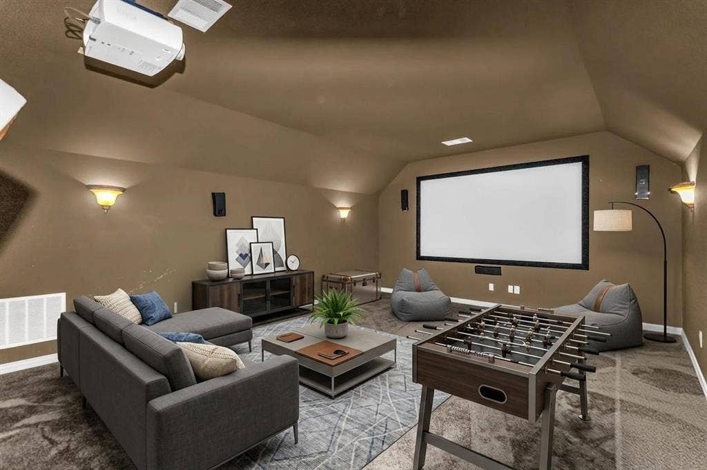1838 Olney Drive, Allen, TX 75013 Integrated ceiling projector, large projection screen, built-in wall sconces, ceiling-mounted speakers, and sloped ceiling design