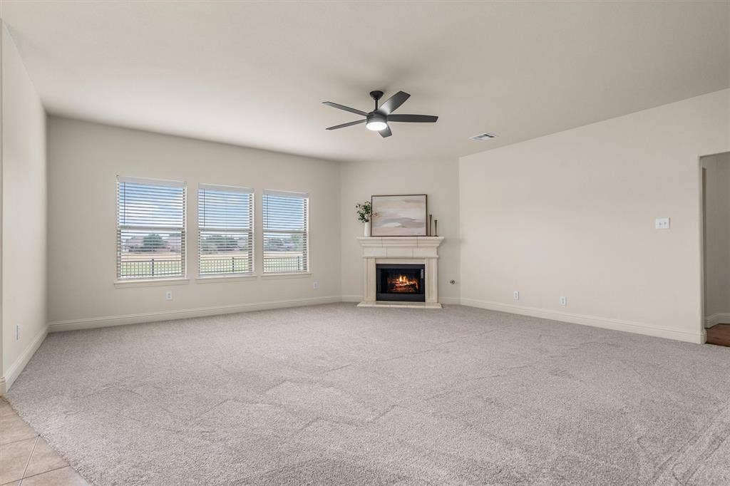 Spacious living room with cozy fireplace and a wall of windows