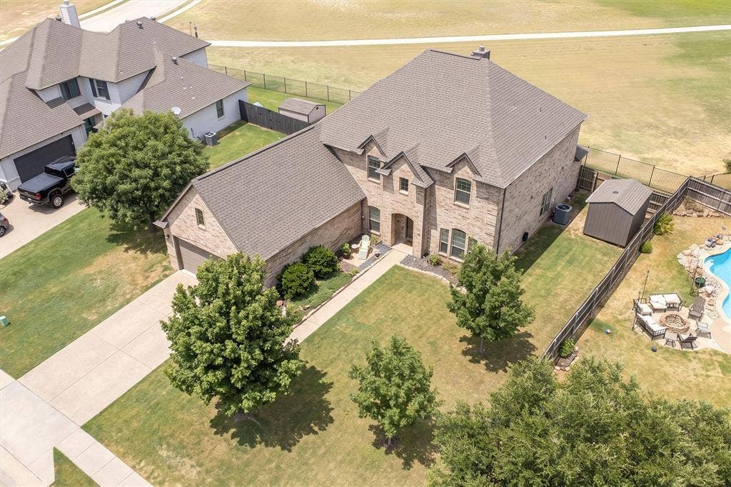Aerial view showcasing the full property and driveway