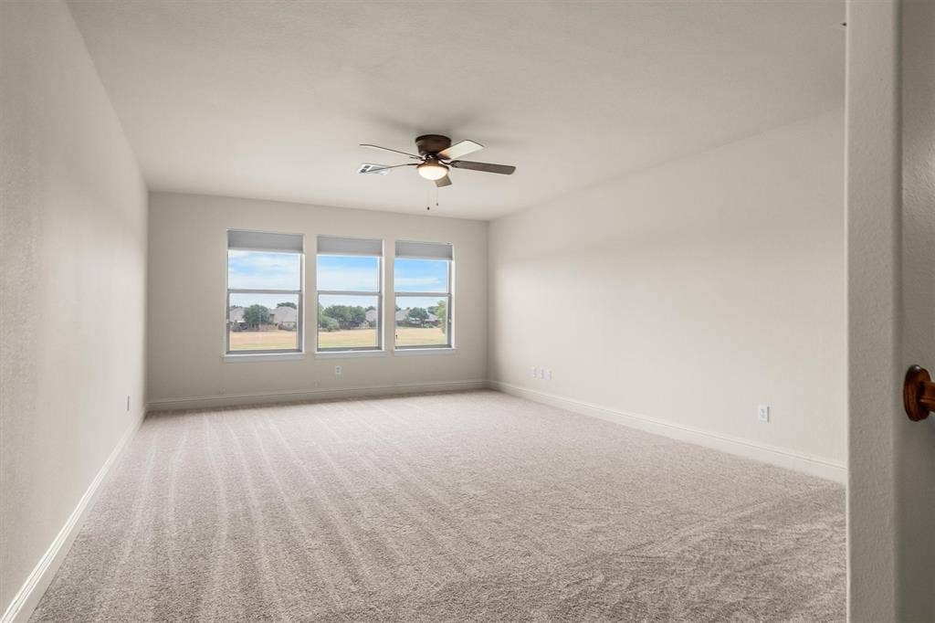 Bright, versatile room with ceiling fan, ready for your vision