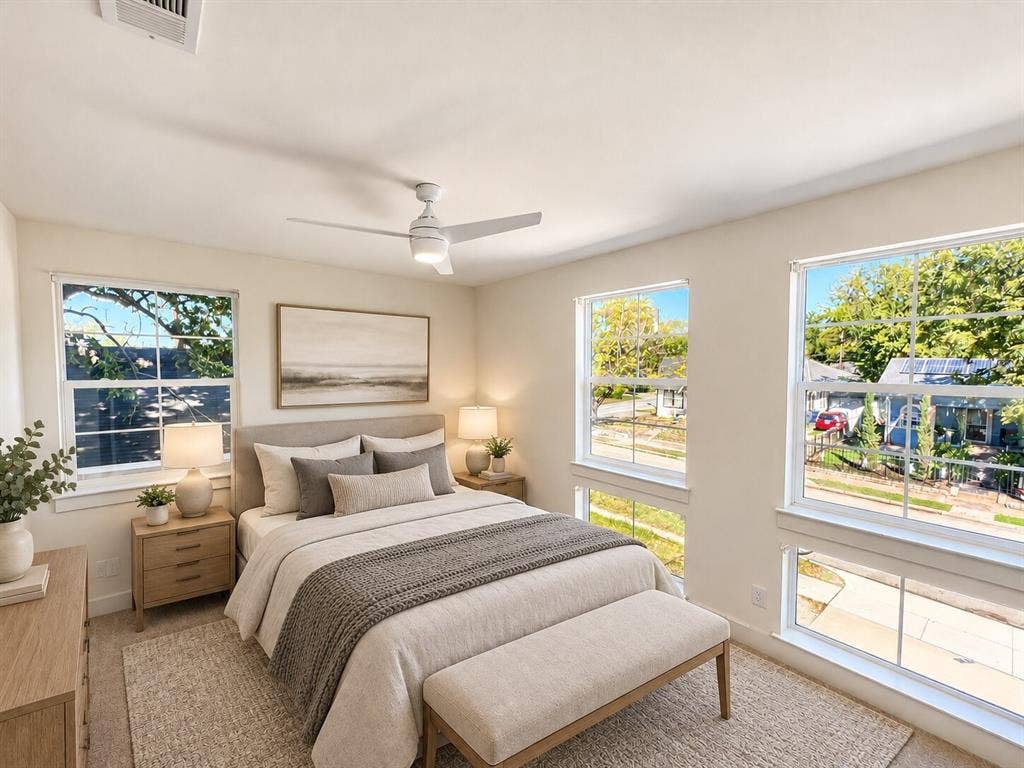 Virtually staged -Multiple large windows, ceiling fan, carpet flooring, and a recessed ceiling vent