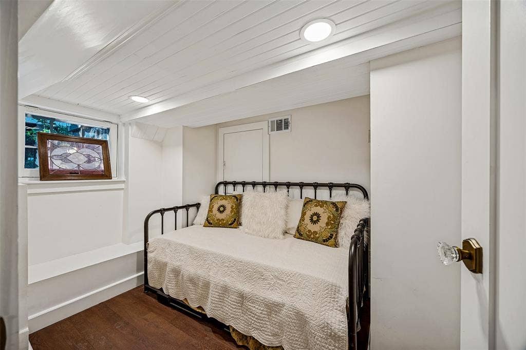 320 E 5th Street, Dallas, TX 75203 Wood-finish flooring with white baseboards, a white paneled ceiling with recessed lighting, and a white-painted window frame