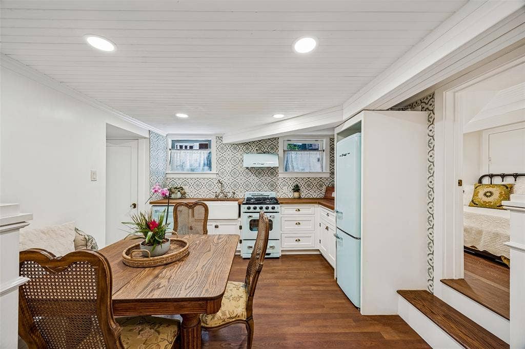 320 E 5th Street, Dallas, TX 75203 Full kitchen in basement Wood-finish flooring, recessed lighting, white wood panel ceiling, kitchen with white cabinetry, wood countertops, patterned tile backsplash, and a farmhouse sink