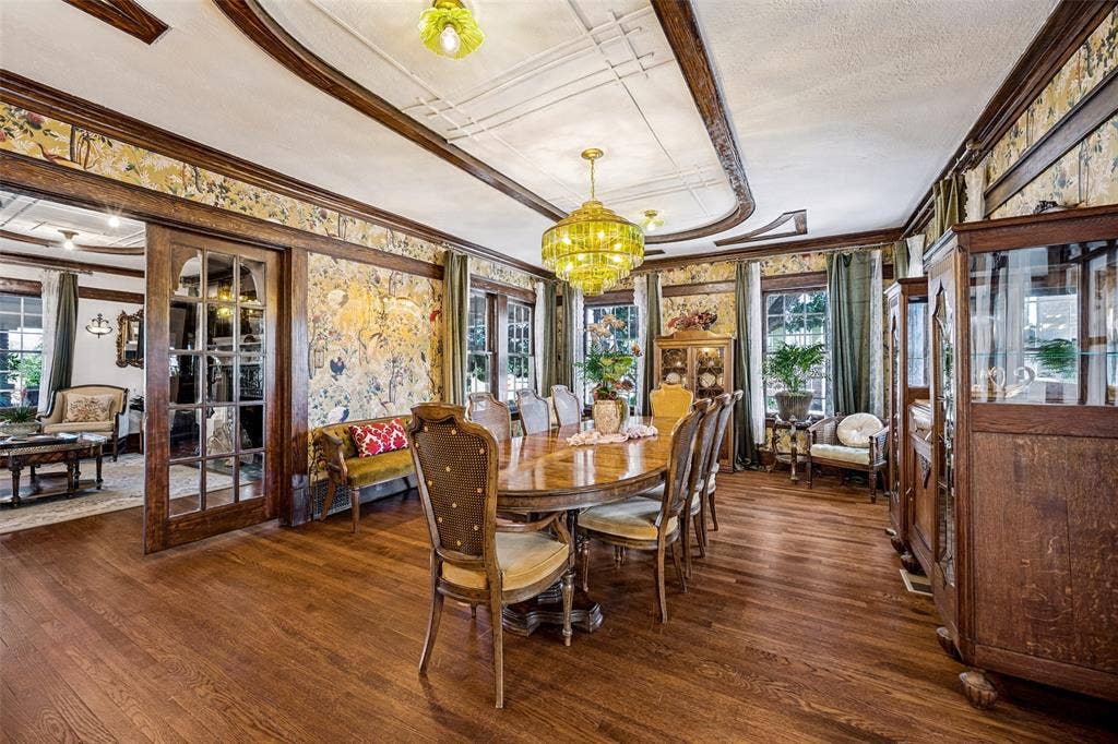 320 E 5th Street, Dallas, TX 75203 Hardwood flooring, ornate ceiling trim, decorative wall coverings, French doors, and prominent windows with drapery