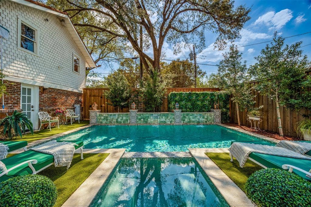 320 E 5th Street, Dallas, TX 75203 Shingle-sided exterior with brick foundation, French door access, rectangular swimming pool, and artificial turf surrounds