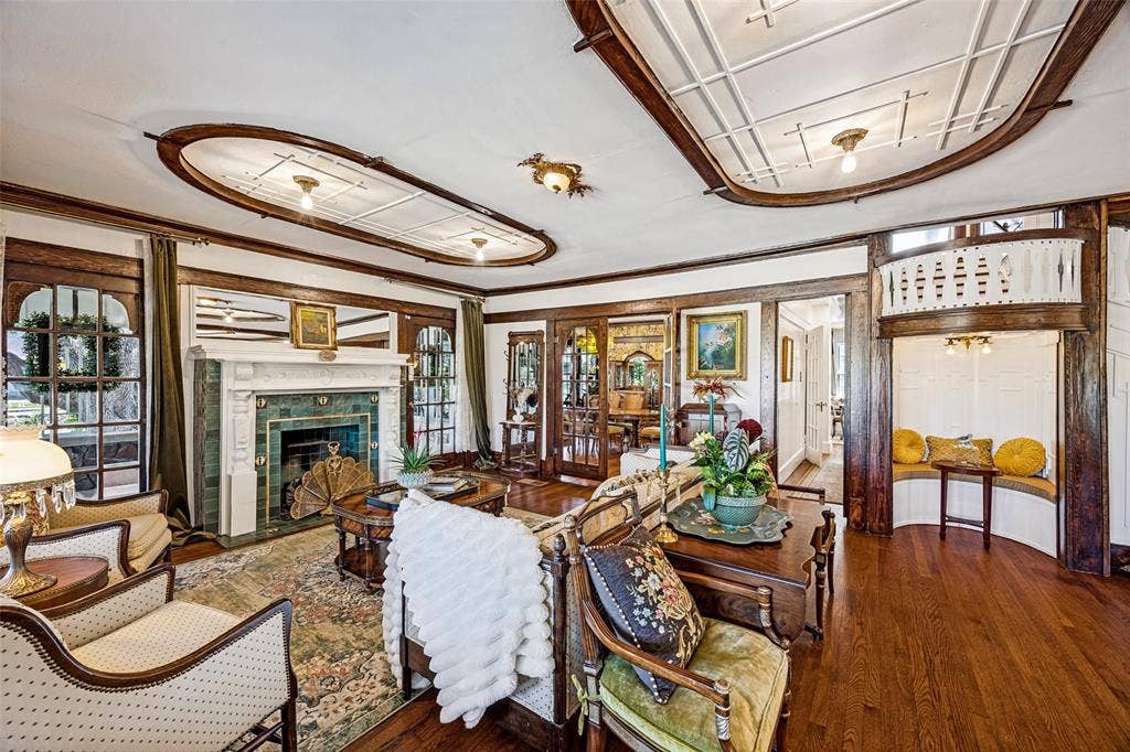 320 E 5th Street, Dallas, TX 75203 Hardwood flooring, decorative ceiling details, built-in fireplace with a tile surround, and an integrated window seat