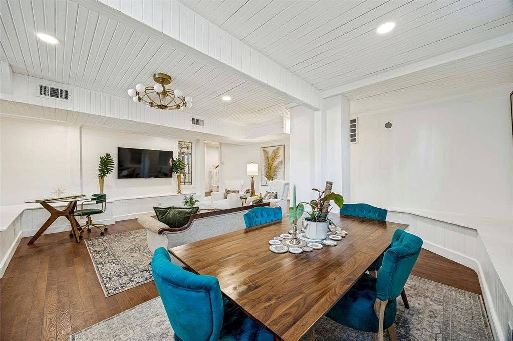 320 E 5th Street, Dallas, TX 75203 Open-concept living area featuring wood-finish flooring, a contemporary chandelier, recessed lighting, and white shiplap ceiling accents