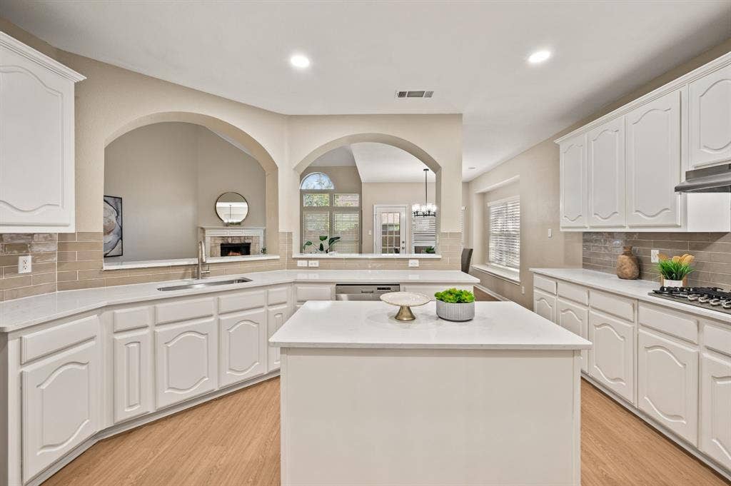 Beautiful arched openings connect the kitchen to the living room, keeping the conversation flowing while you cook.