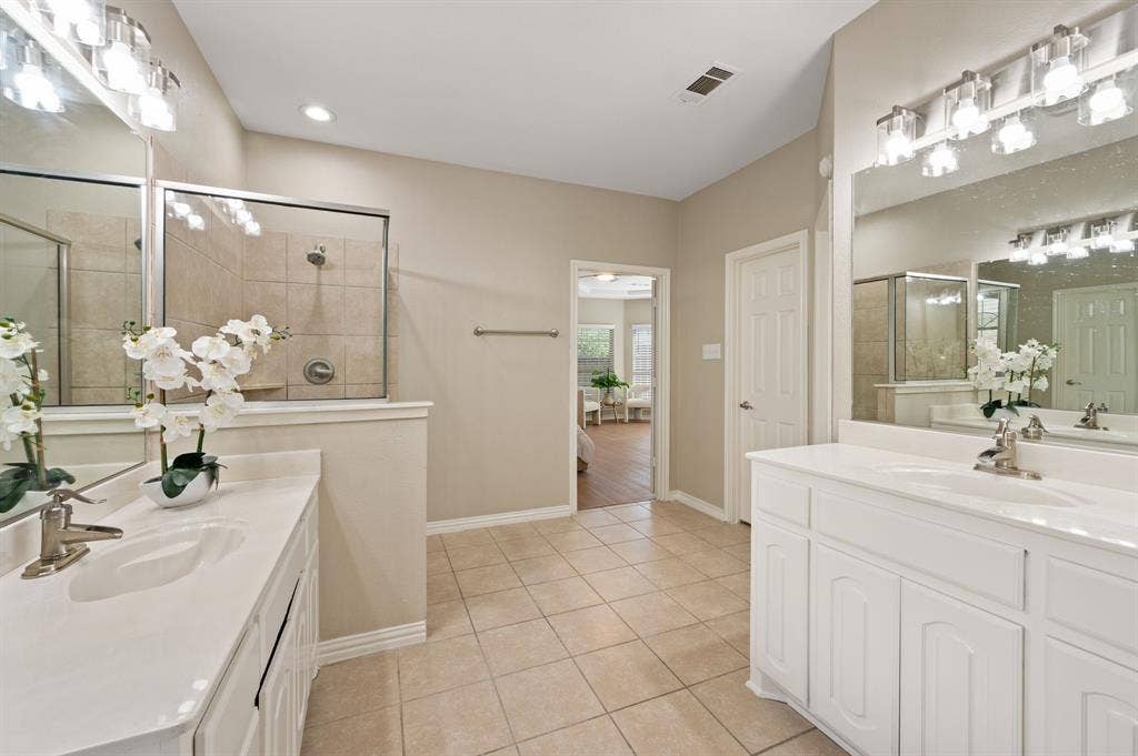 Enjoy plenty of elbow room with separate vanities, abundant cabinet storage & a spacious layout connecting to the primary bedroom.