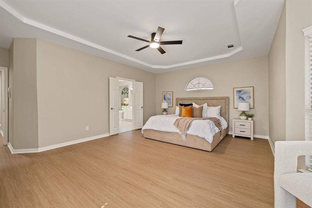 With generous proportions, warm wood-look flooring & a beautifully detailed ceiling, this bedroom offers plenty of space to relax & recharge.