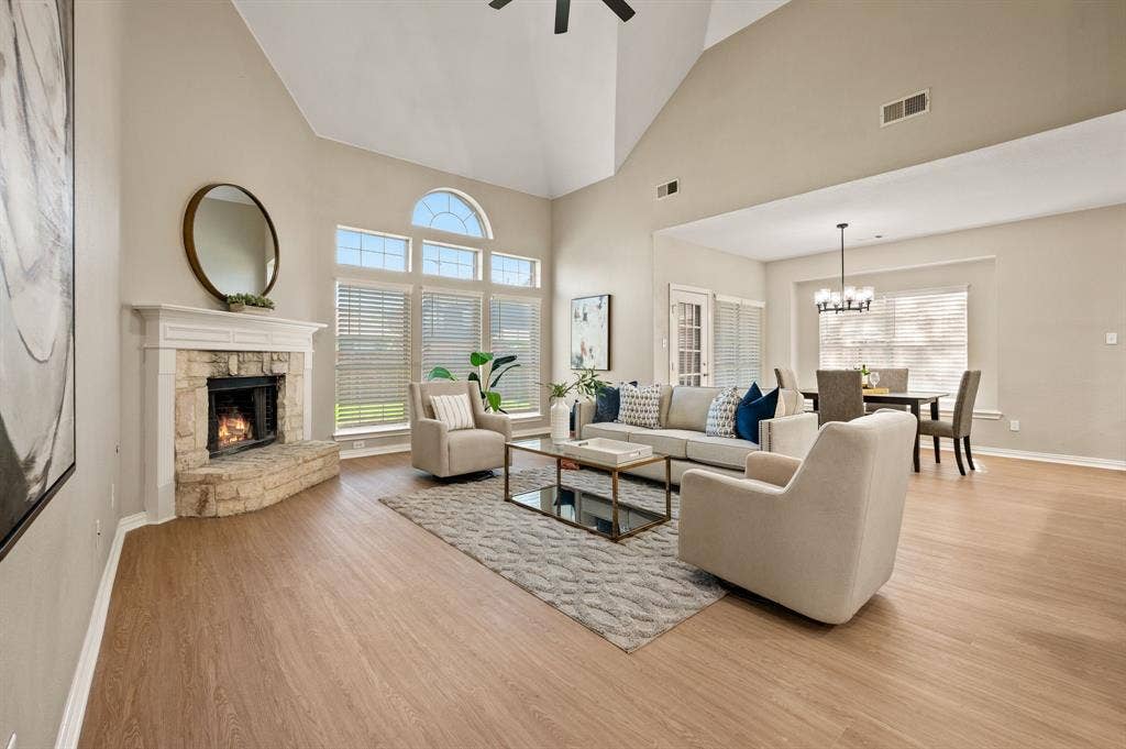 Stretch out & settle in! This airy living room features soaring ceilings, a corner fireplace & an easy connection to the breakfast area.