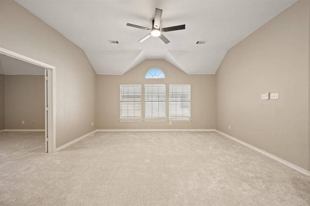 Make it your own! This spacious upstairs room features a vaulted ceiling, new carpeting & a charming arched window accent.