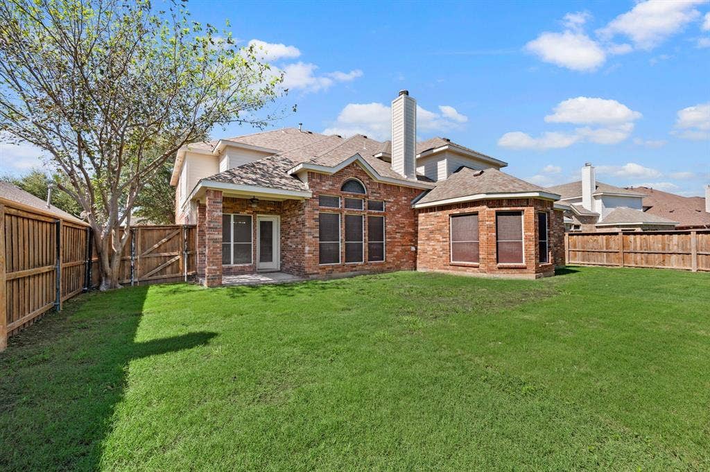 Bring the fun outside! The spacious fenced backyard features a large grassy lawn, & a patio just off the home.