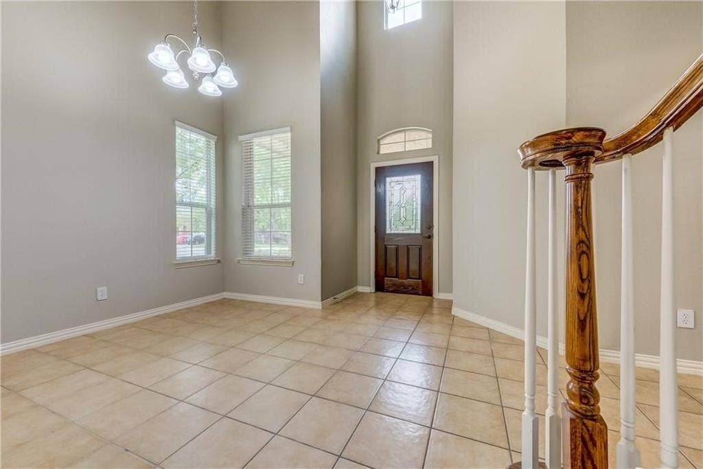 2300 Reston Drive, McKinney, TX 75072 Foyer entrance with a notable chandelier, a high ceiling, and light tile floors