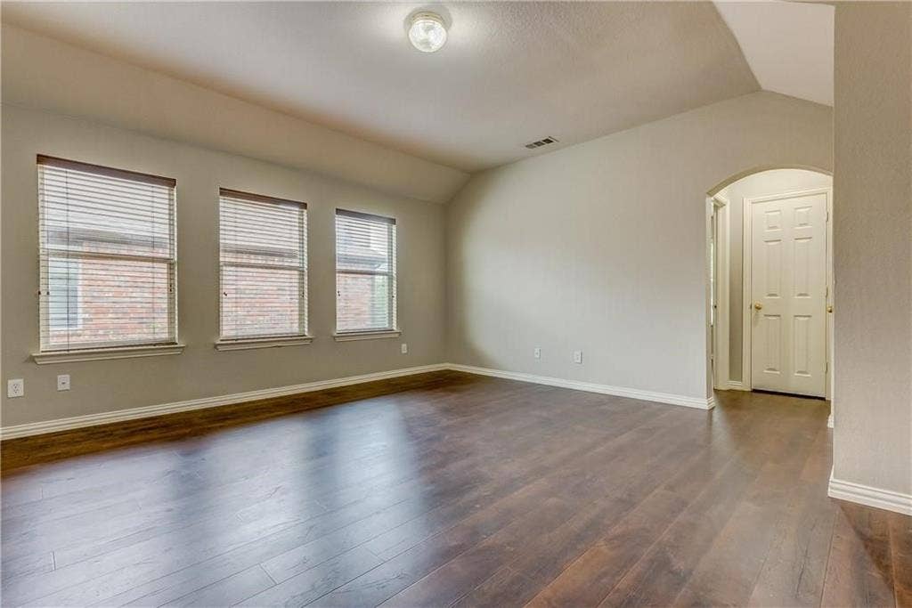 2300 Reston Drive, McKinney, TX 75072 Unfurnished room with dark wood-type flooring and lofted ceiling