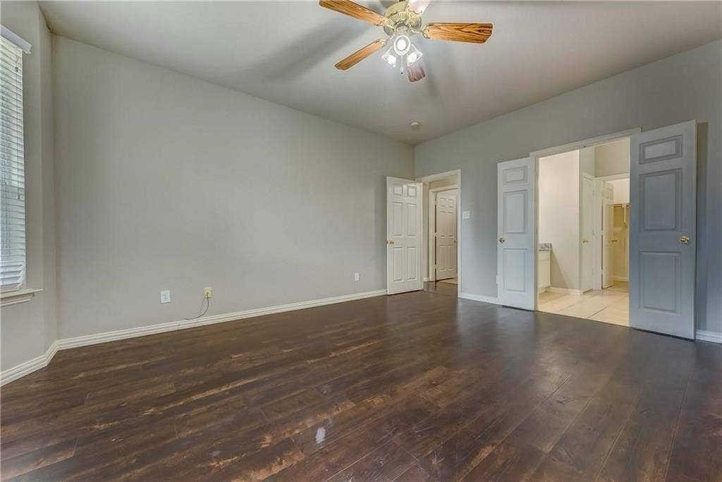 2300 Reston Drive, McKinney, TX 75072 Unfurnished bedroom featuring ensuite bath, ceiling fan, and hardwood / wood-style floors