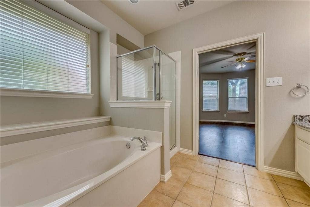 2300 Reston Drive, McKinney, TX 75072 Bathroom featuring tile flooring, ceiling fan, vanity, and plus walk in shower