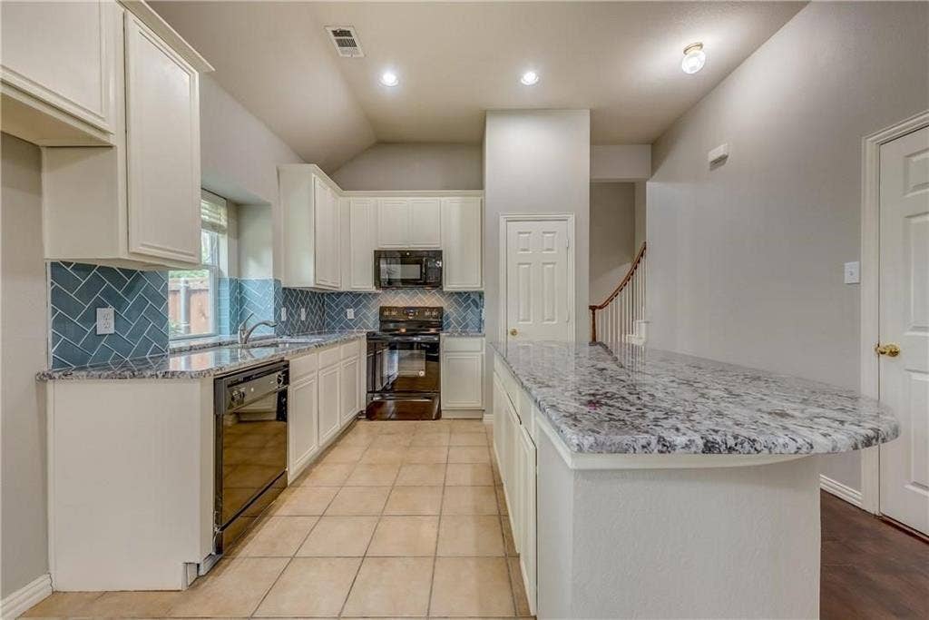 2300 Reston Drive, McKinney, TX 75072 Kitchen with white cabinetry, black appliances, and backsplash