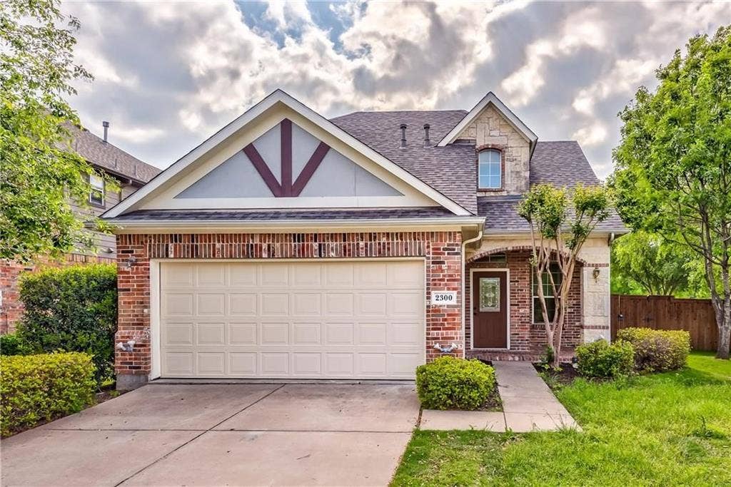 2300 Reston Drive, McKinney, TX 75072 View of front of property with a garage and a front lawn