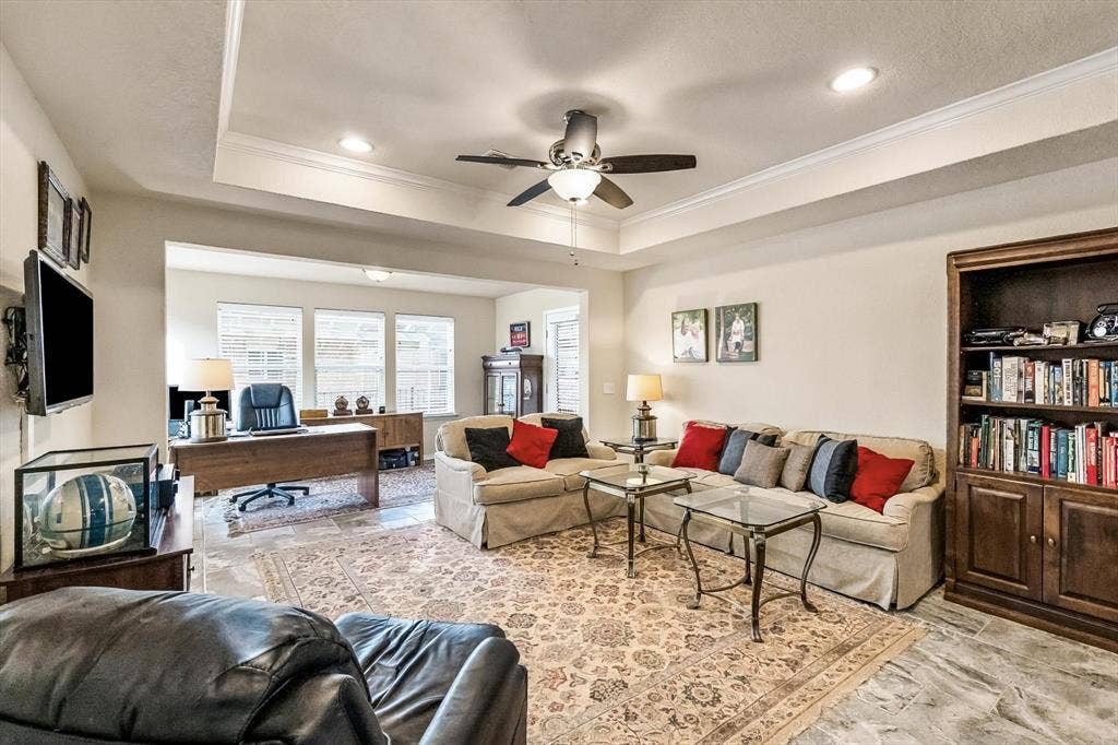 Tray ceiling with recessed lighting, ceiling fan, large windows and entry to Sunroom