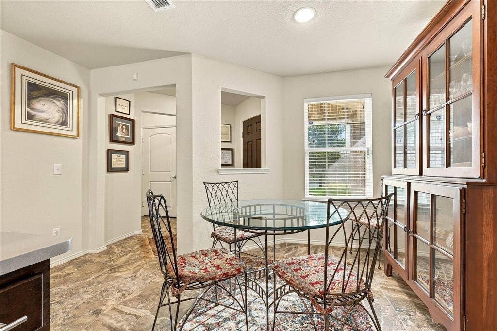 Interior area featuring stone-finish tile flooring, a recessed wall opening, and inset ceiling lighting