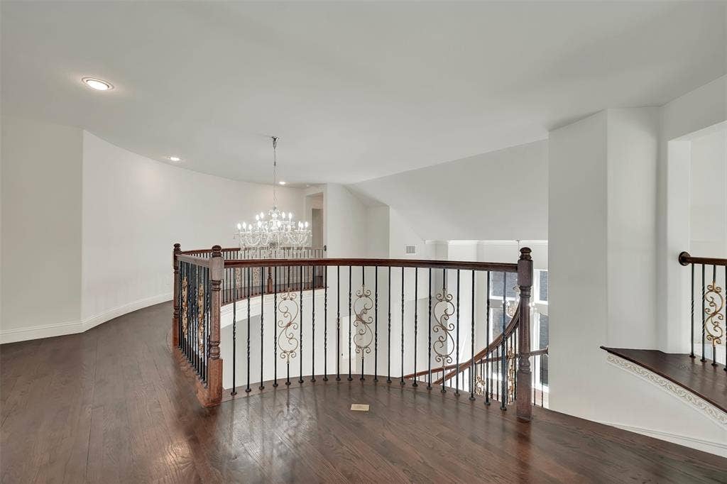 302 Torch Lily Lane, Wylie, TX 75098 Hardwood flooring, wrought iron balusters with ornate details, recessed lighting, and a crystal chandelier