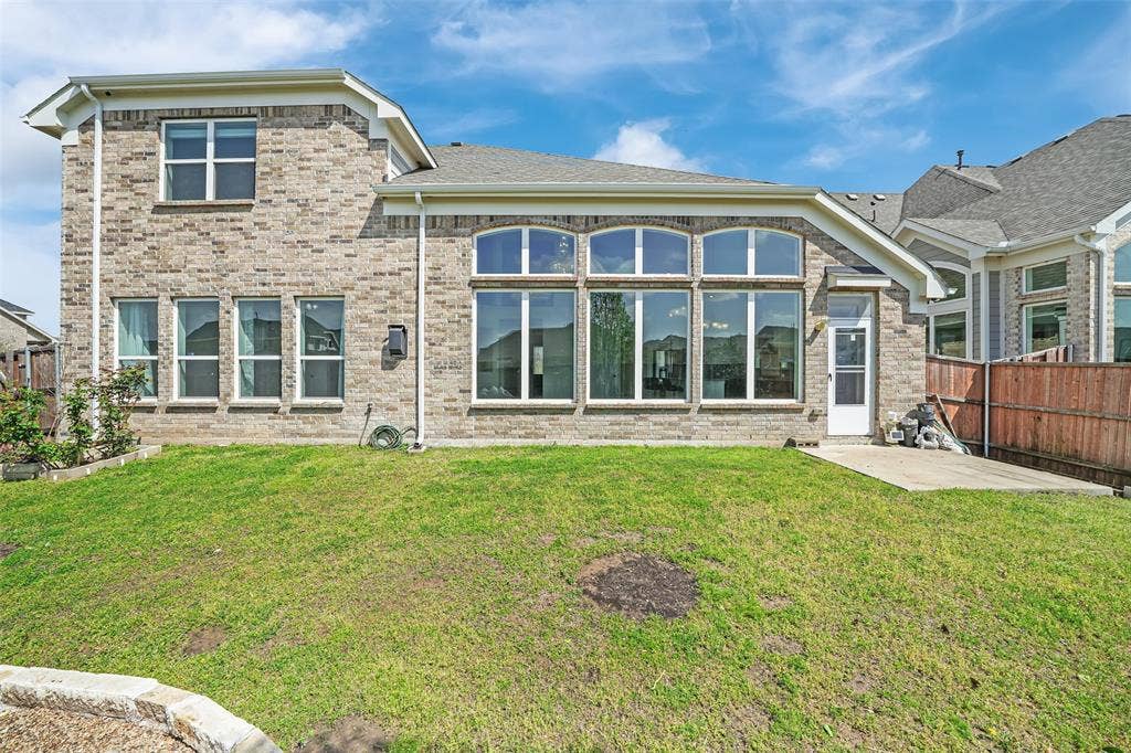 302 Torch Lily Lane, Wylie, TX 75098 Brick exterior with a partial wood fence