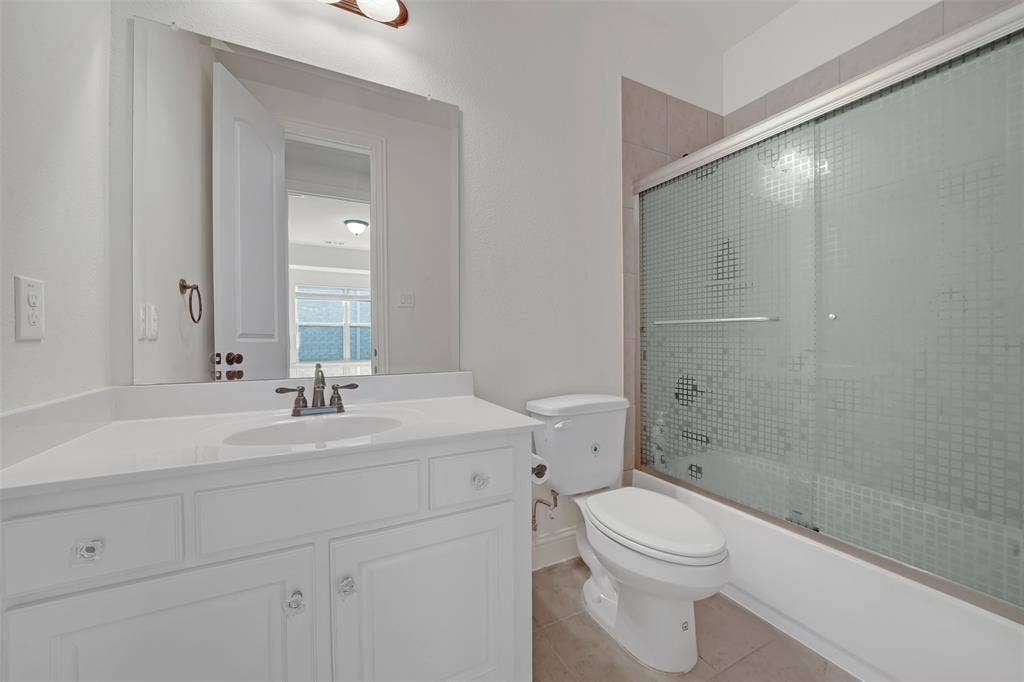 302 Torch Lily Lane, Wylie, TX 75098 White vanity with integrated sink, bronze-finish faucet, and crystal-style drawer pulls