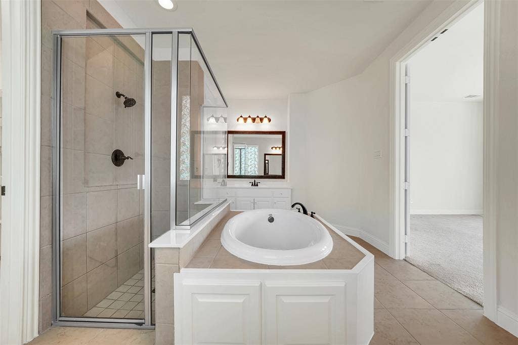 302 Torch Lily Lane, Wylie, TX 75098 Built-in soaking tub, walk-in shower with glass enclosure, white paneled vanity, and recessed lighting
