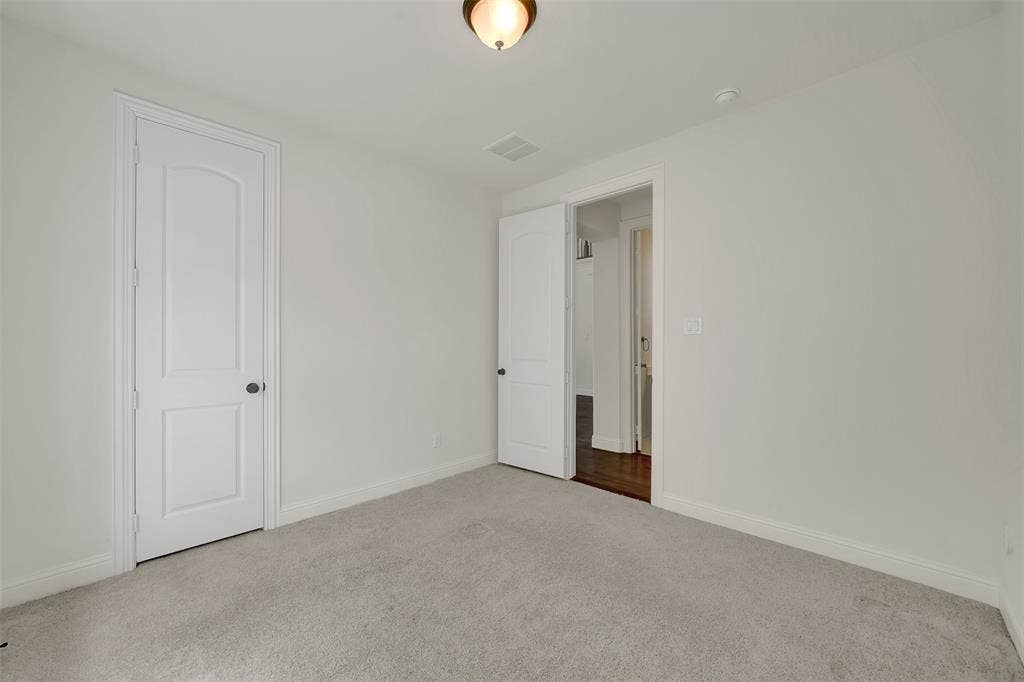 302 Torch Lily Lane, Wylie, TX 75098 Neutral wall tones, light-colored carpeting, white trim, and white paneled doors