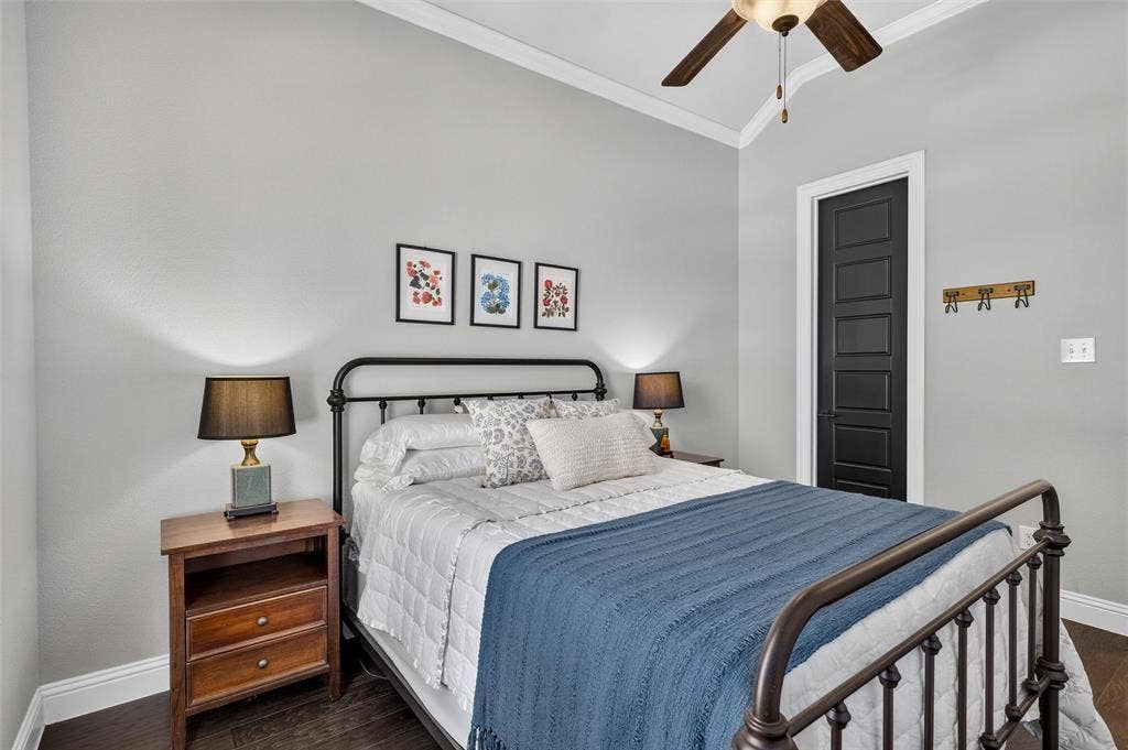 7601 Calhoun Cove, McKinney, TX 75071 Vaulted ceiling with crown molding, ceiling fan, dark wood-finish flooring, and a five-panel interior door