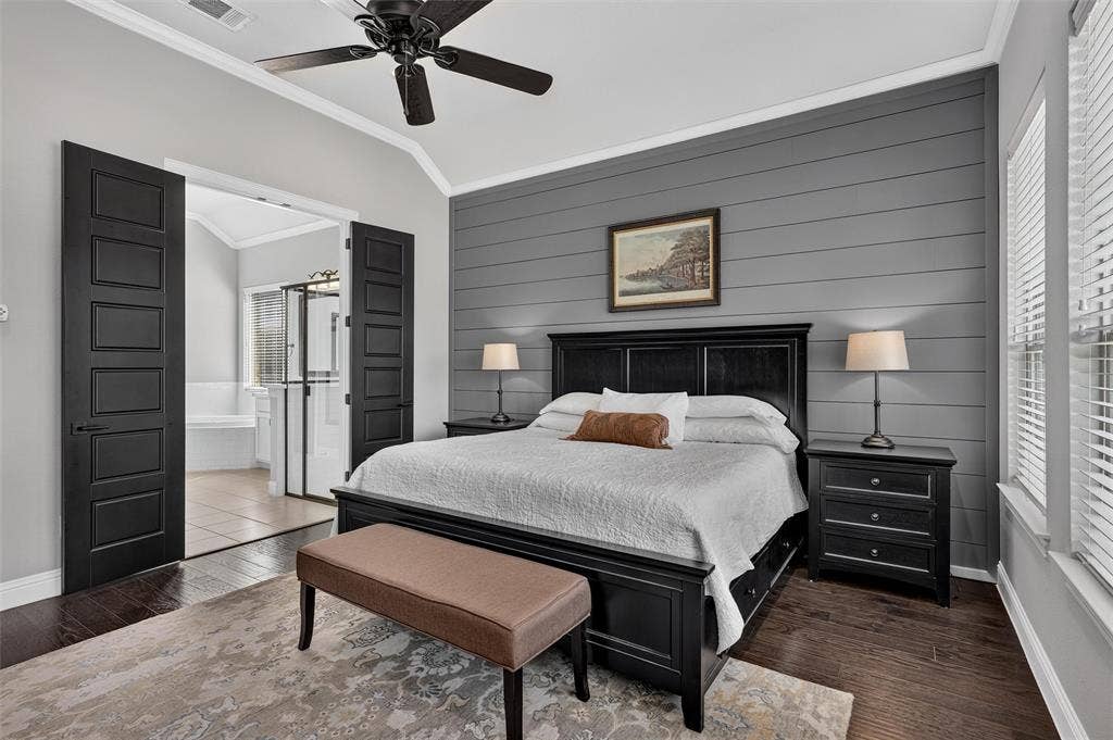 7601 Calhoun Cove, McKinney, TX 75071 Vaulted ceiling with a ceiling fan, dark wood-finish flooring, accent wall with horizontal paneling, double doors, and a window with blinds