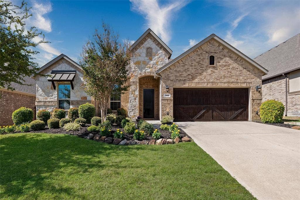 7601 Calhoun Cove, McKinney, TX 75071 Brick and stone exterior with a gabled roof