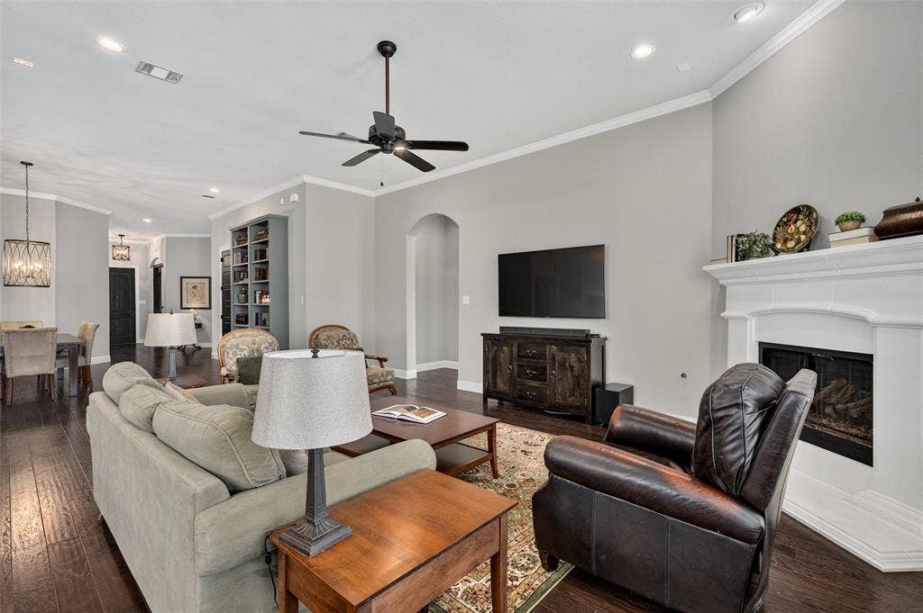 7601 Calhoun Cove, McKinney, TX 75071 Hardwood flooring throughout, recessed lighting, crown molding, a built-in fireplace, and an arched entry