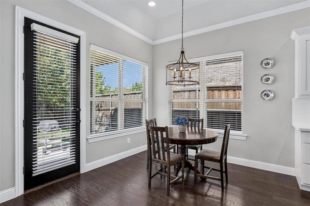 7601 Calhoun Cove, McKinney, TX 75071 Dark wood-finish flooring, white trim, and light gray wall paint