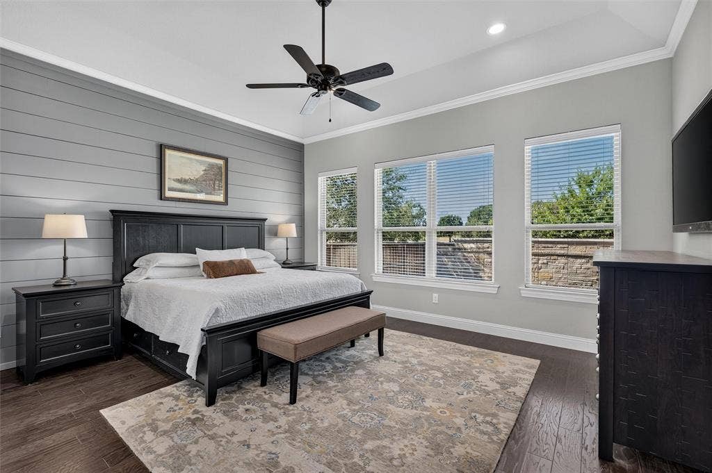 7601 Calhoun Cove, McKinney, TX 75071 Accent wall with horizontal paneling, wood-finish flooring, ceiling fan, recessed lighting, and multiple windows