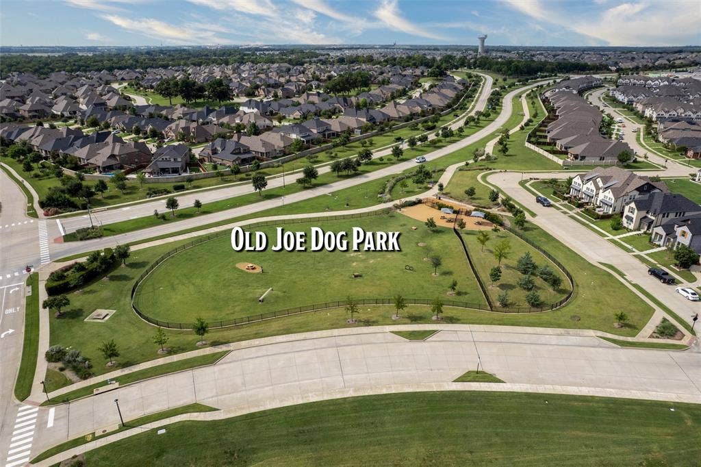 7601 Calhoun Cove, McKinney, TX 75071 Community park with a fenced dog park area, surrounded by residential streets and landscaped green spaces