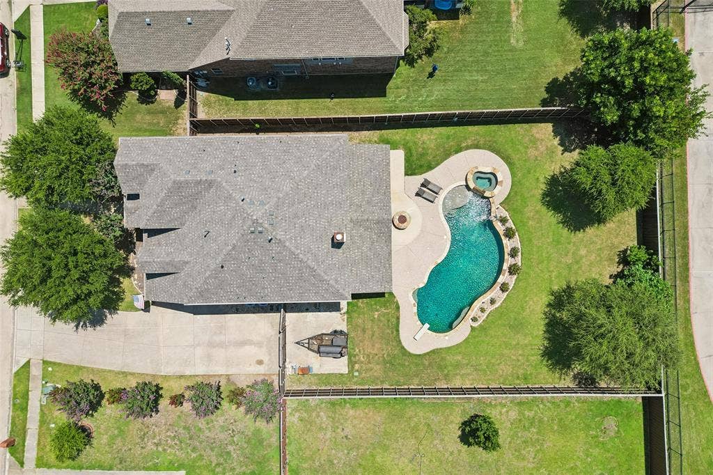 5732 Chateau Drive, Sachse, TX 75048 Expansive backyard featuring a freeform swimming pool, integrated spa, and concrete decking