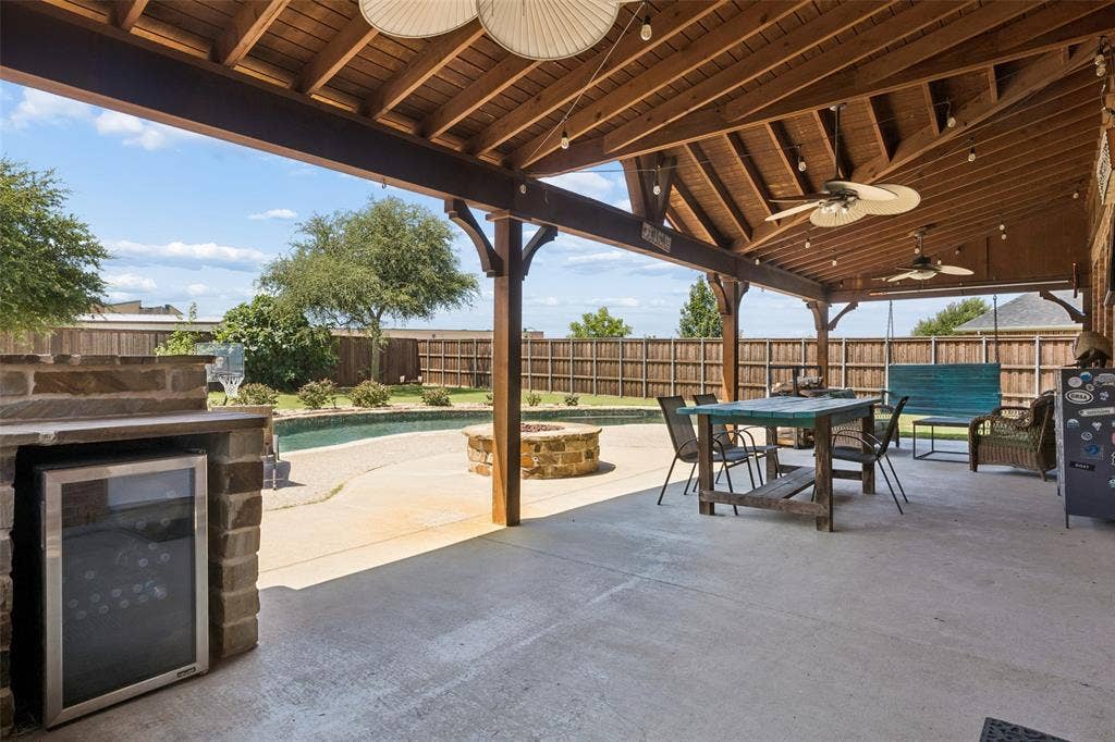 5732 Chateau Drive, Sachse, TX 75048 Another great angle of the covered patio overlooking pool and firepit.