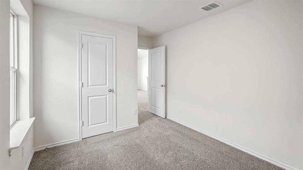 1671 Blaire Drive, Tyler, TX 75702 Neutral gray carpeting, white painted walls, and white trim throughout