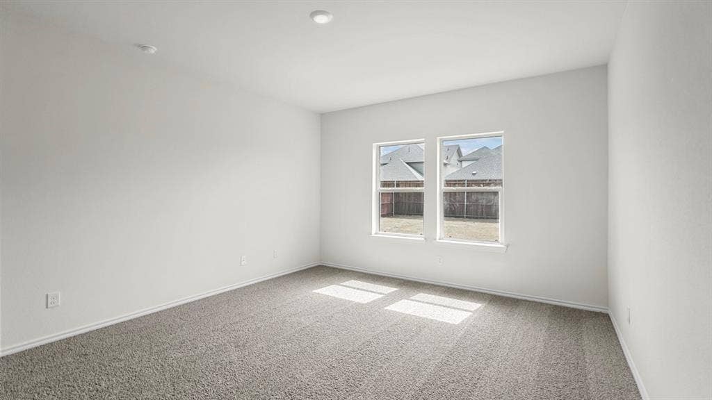 1671 Blaire Drive, Tyler, TX 75702 Neutral wall color, recessed ceiling lighting, light gray carpet, and two windows