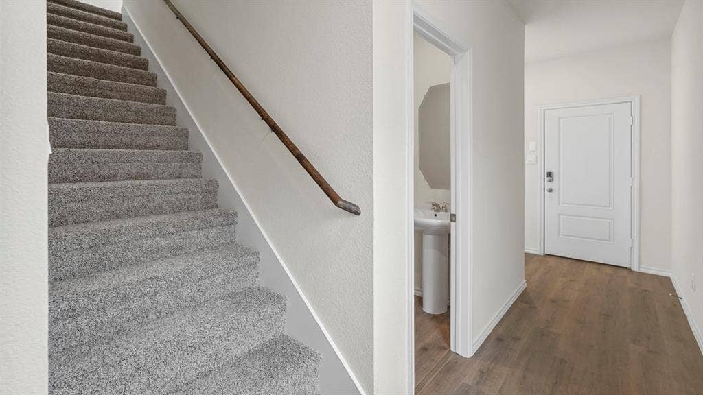 1671 Blaire Drive, Tyler, TX 75702 Carpeted staircase with wooden handrail