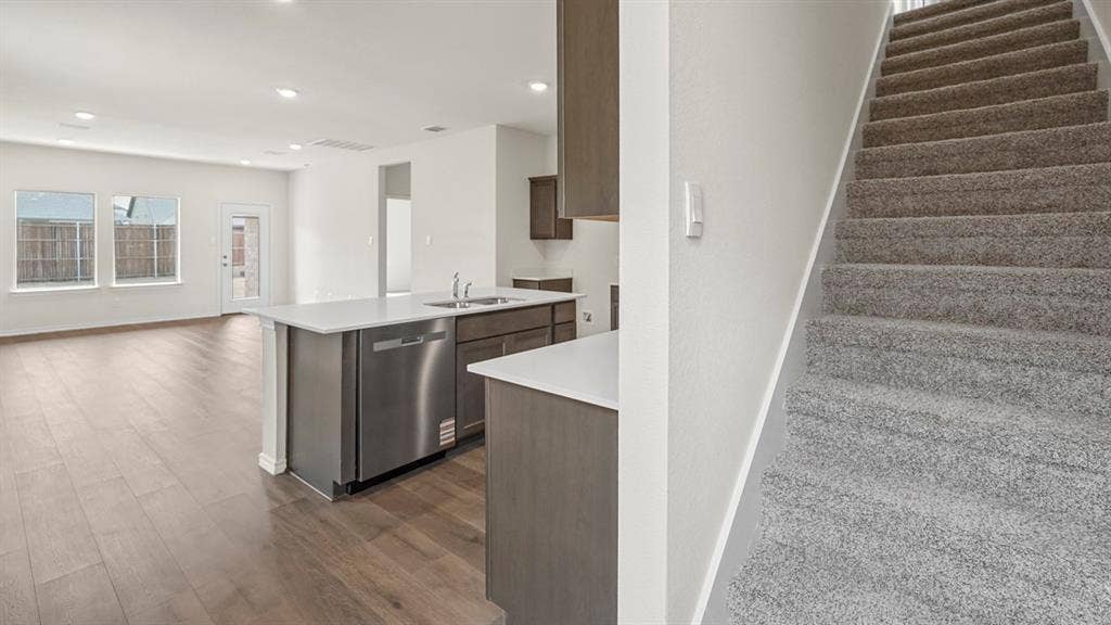1671 Blaire Drive, Tyler, TX 75702 Open-concept living space with wood-finish flooring, recessed lighting, and multiple windows