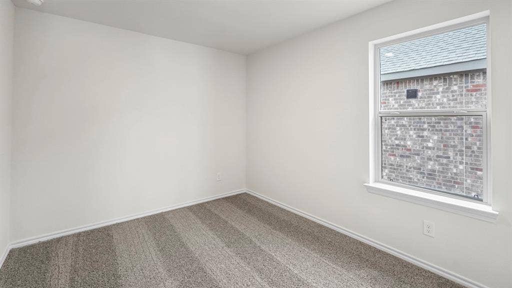 1671 Blaire Drive, Tyler, TX 75702 Neutral wall tones, patterned carpet, and a white-framed window